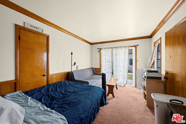 bedroom with wooden walls, light colored carpet, and ornamental molding