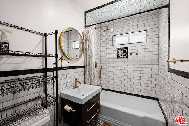 bathroom featuring shower / tub combo, vanity, and tile walls