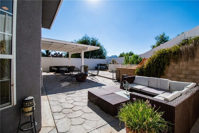 view of patio featuring a pergola and an outdoor living space with a fire pit