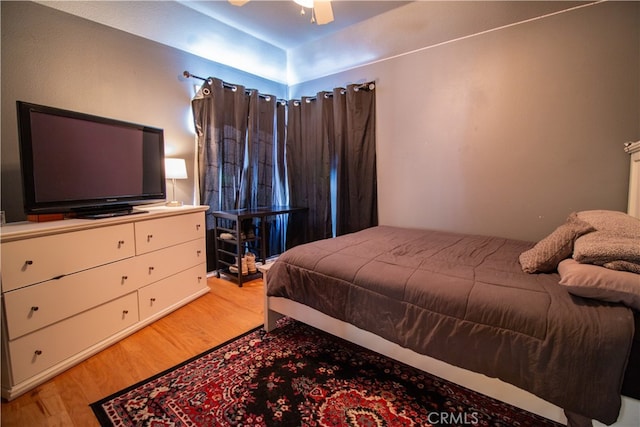 bedroom with ceiling fan and hardwood / wood-style flooring