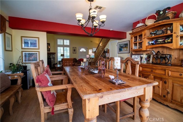 dining area featuring a chandelier and light wood-type flooring