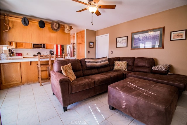 living room with ceiling fan and light tile patterned floors