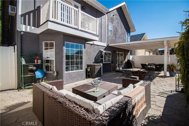 view of patio with central AC, a balcony, and an outdoor living space