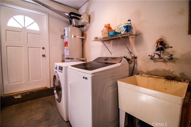 clothes washing area with water heater, washer and clothes dryer, and sink