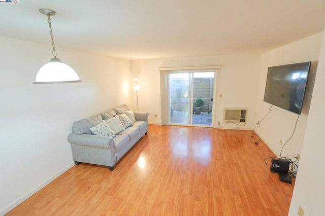 unfurnished living room featuring an AC wall unit and wood-type flooring