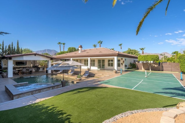 exterior space with a pool with hot tub, a patio area, and a mountain view