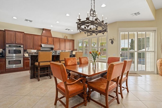 tiled dining space with a notable chandelier and a wealth of natural light