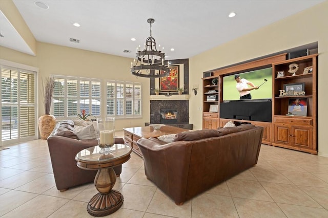 tiled living room featuring a fireplace, a chandelier, and built in shelves