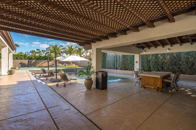 view of patio featuring an outdoor bar, a fenced in pool, and a pergola