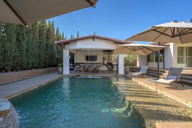 view of swimming pool featuring pool water feature and a patio