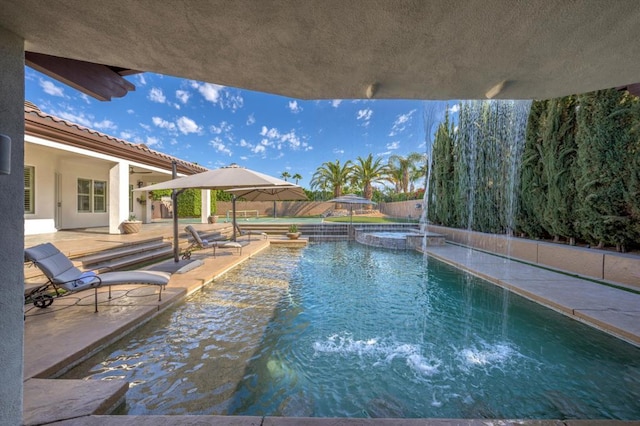 view of pool featuring a patio area and an in ground hot tub