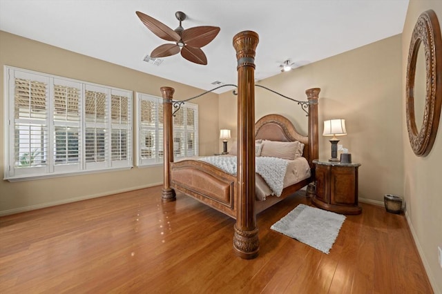 bedroom with ceiling fan and hardwood / wood-style flooring