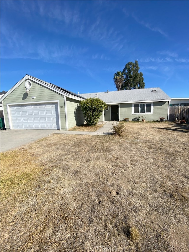 single story home with a front yard and a garage