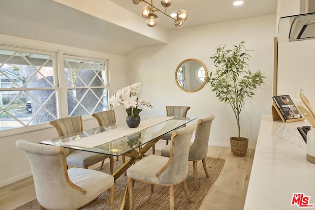 dining space featuring a chandelier and light hardwood / wood-style floors