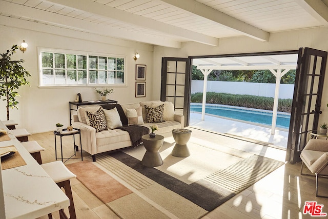 living room with beamed ceiling, light hardwood / wood-style floors, and wooden ceiling