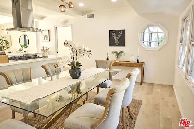 dining space with light hardwood / wood-style floors