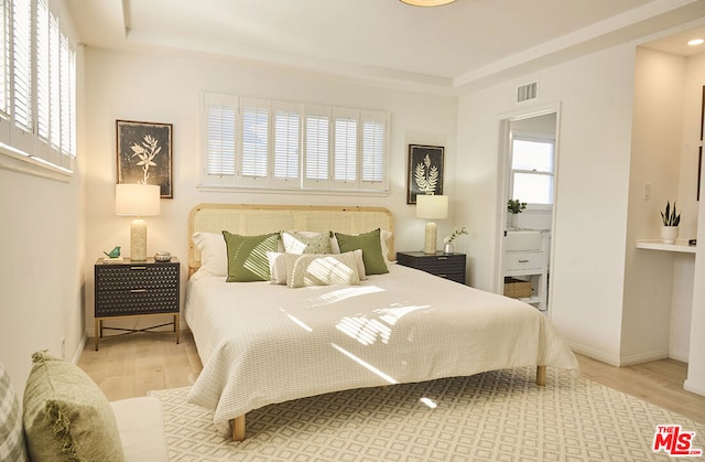 bedroom with wood-type flooring