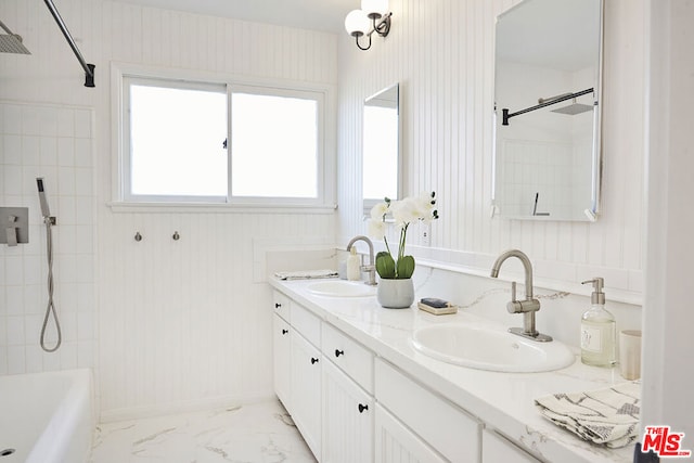 bathroom with vanity and tiled shower / bath