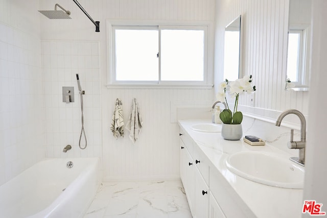 bathroom featuring tiled shower / bath combo and vanity