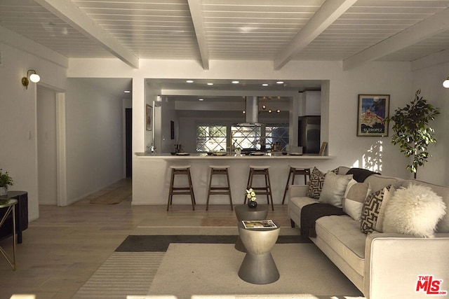 living room featuring beam ceiling and hardwood / wood-style flooring