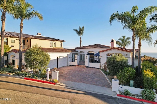 mediterranean / spanish house with a garage