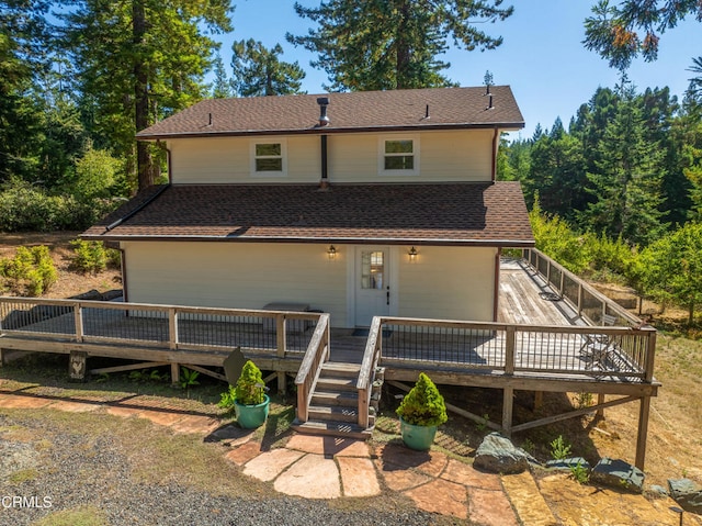 back of property featuring a wooden deck