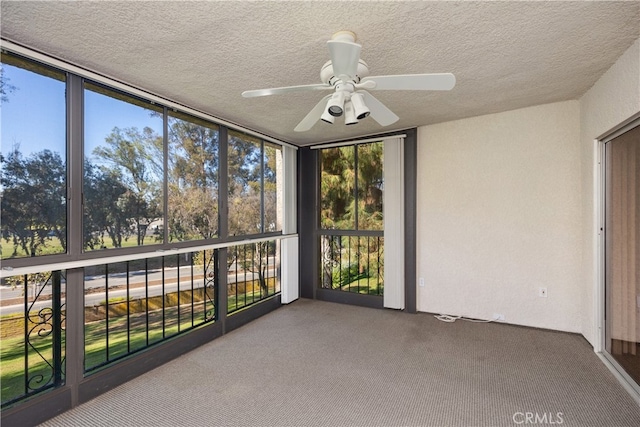 unfurnished sunroom with ceiling fan