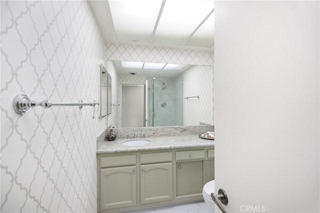 bathroom featuring vanity, toilet, and an enclosed shower