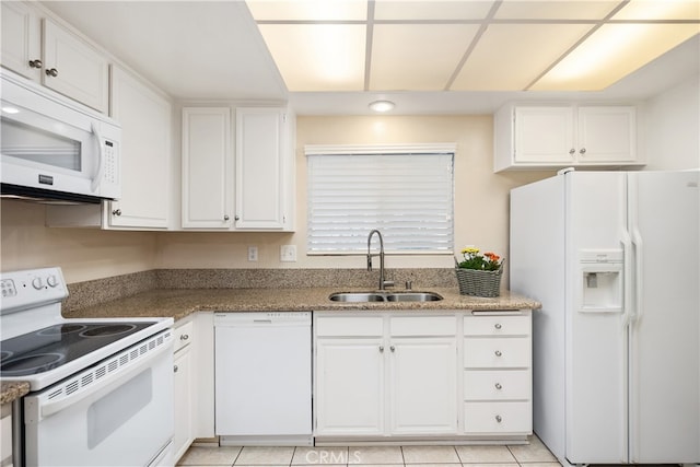 kitchen with white appliances, sink, and white cabinets