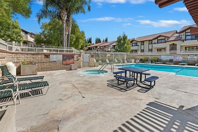 view of pool featuring a patio and a hot tub