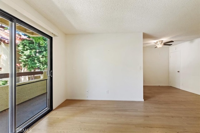 empty room featuring ceiling fan, a textured ceiling, and light hardwood / wood-style flooring