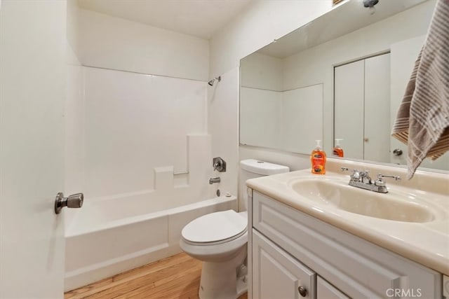 full bathroom with wood-type flooring, bathing tub / shower combination, vanity, and toilet