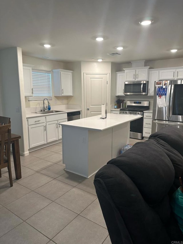 kitchen featuring a kitchen island, white cabinetry, and stainless steel appliances