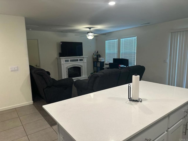 tiled living room with ceiling fan