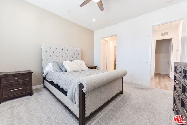 bedroom with ceiling fan and light colored carpet