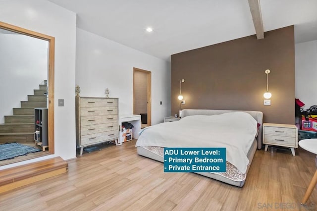 bedroom featuring beam ceiling and hardwood / wood-style flooring