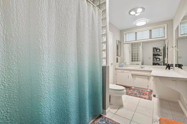 bathroom with vanity, toilet, and tile patterned floors