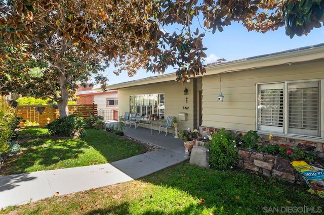 exterior space featuring a lawn and a patio