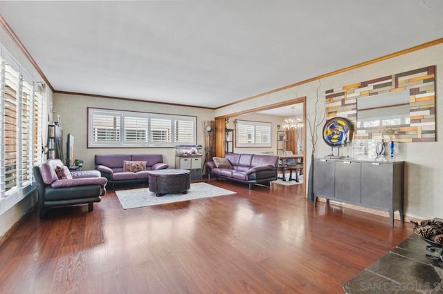 living room with crown molding, dark hardwood / wood-style flooring, and a chandelier