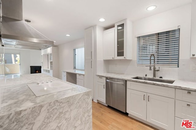 kitchen featuring stainless steel dishwasher, white cabinets, and sink