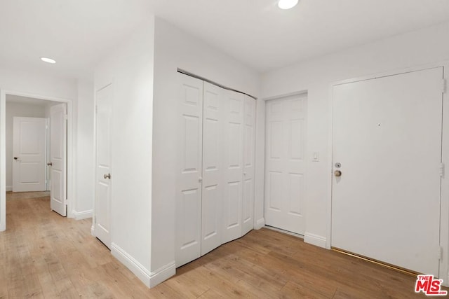 corridor with light hardwood / wood-style flooring