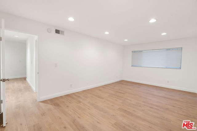 spare room featuring light hardwood / wood-style flooring