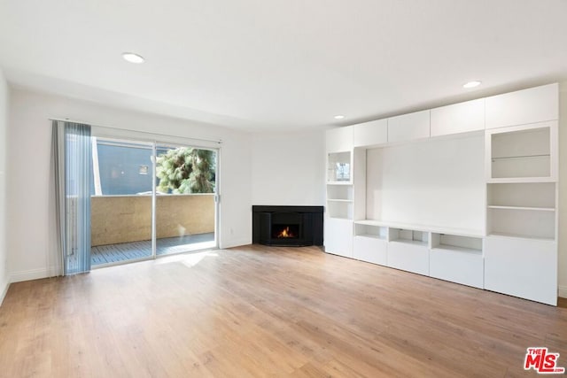 unfurnished living room featuring light wood-type flooring