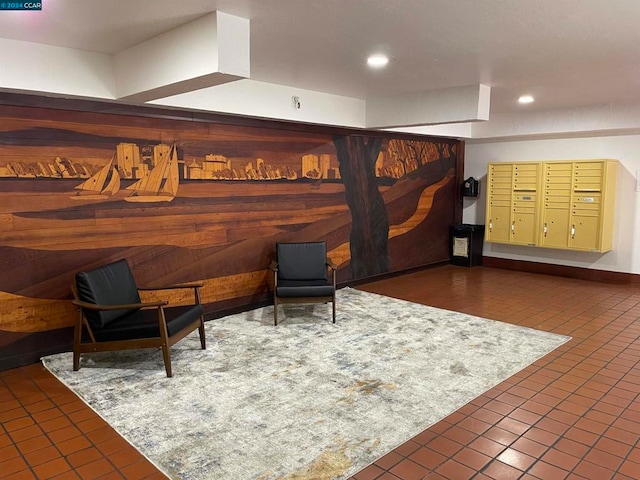 living area featuring mail boxes, wooden walls, and dark tile patterned floors