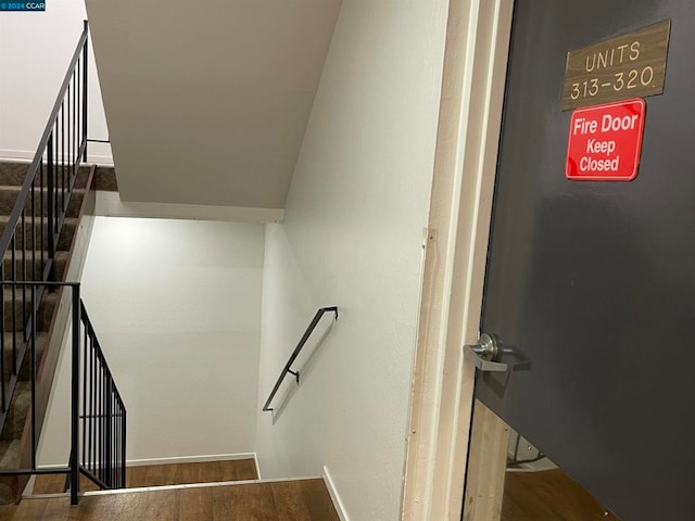 stairway featuring hardwood / wood-style flooring