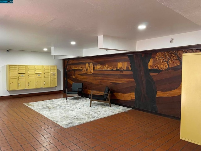 sitting room featuring dark tile patterned floors and a mail area