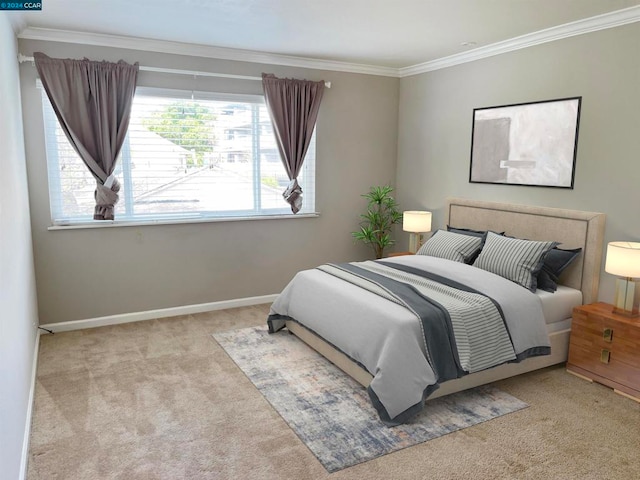 bedroom with ornamental molding and light colored carpet