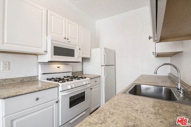 kitchen featuring white cabinets, white appliances, and sink