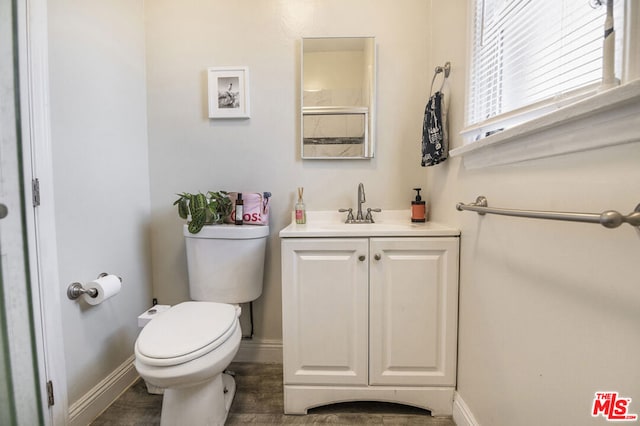 bathroom featuring hardwood / wood-style flooring, vanity, and toilet