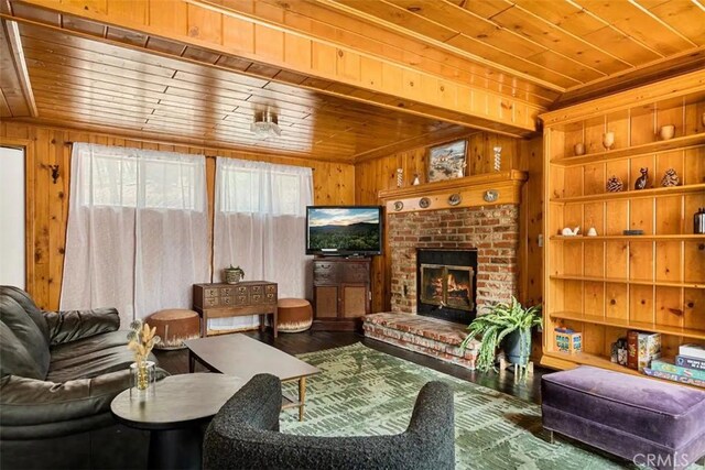 living room featuring a brick fireplace, wooden ceiling, and wooden walls